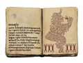 A book containing a depiction of Gro-goroth, drawn in a tribal artistic style.